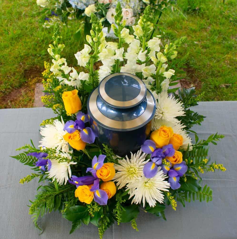 A cremation urn surrounded by flowers